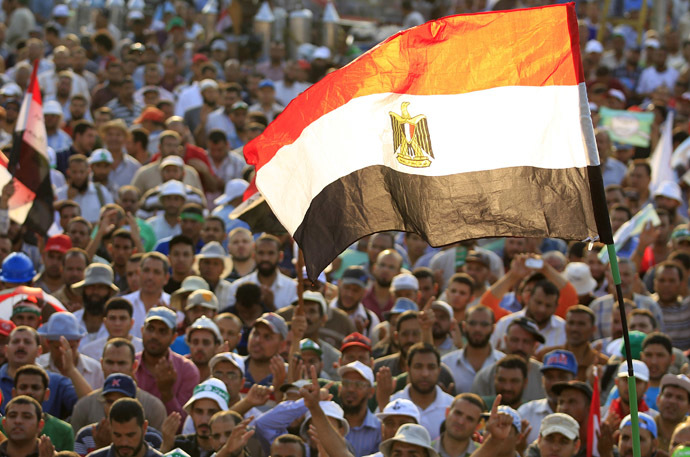 Members of the Muslim Brotherhood and supporters of Egyptian
  President Mohamed Morsi shout slogans and waves an Egyptian flag
  during a protest around the Raba El-Adwyia mosque square in Nasr
  City, in the suburb of Cairo June 29, 2013. (Reuters)