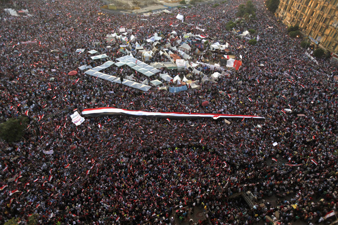 A large Egyptian flag
  is seen as protesters opposing Egyptian President Mohamed Morsi
  shout slogans against him and Brotherhood members during a
  protest at Tahrir Square in Cairo June 30, 2013. (Reuters)