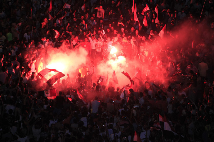 Protesters opposing Egyptian President Mohamed Morsi gather
  near a lit a flare during a protest at Tahrir Square in Cairo
  June 30, 2013. (Reuters)