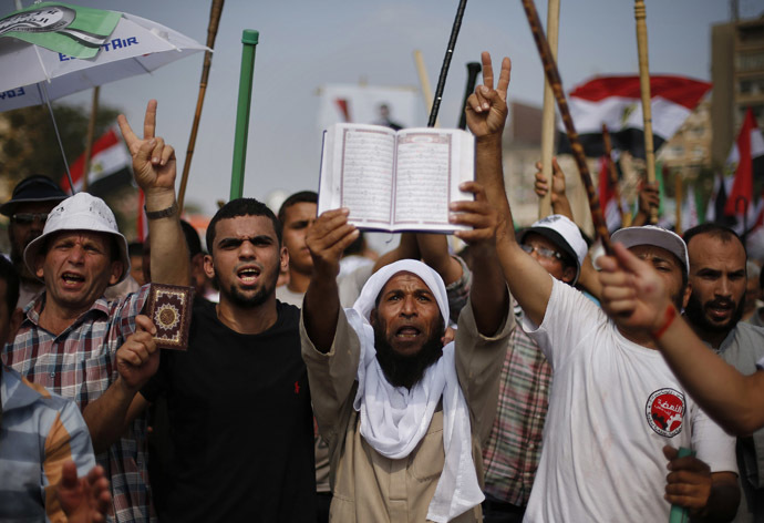 Supporters of
  Egyptian President Mohamed Morsi hold copies of the Koran during
  a protest around the Raba El-Adwyia mosque square in Nasr City,
  in the suburb of Cairo June 30, 2013. (Reuters) 