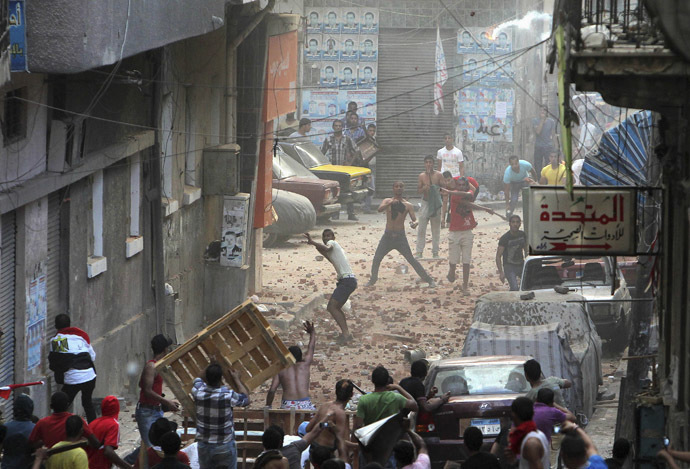 Anti-Morsi protesters
  (bottom) and residents of an area in Sidi Gaber, clash in a side
  street off a main street where a massive anti-Morsi protest is
  taking place, in Alexandria, June 30, 2013. (Reuters)