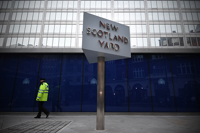 A police support officer walks past a sign outside New Scotland Yard, the headquarters of the Metropolitan Police, in central London on January 11, 2013, following the report by the Metropolitan Police and NSPCC (National Society for the Prevention of Cruelty to Children) detailing 50 years of allegations of sexual abuse by former BBC presenter Jimmy Savile (AFP Photo / Carl Court)